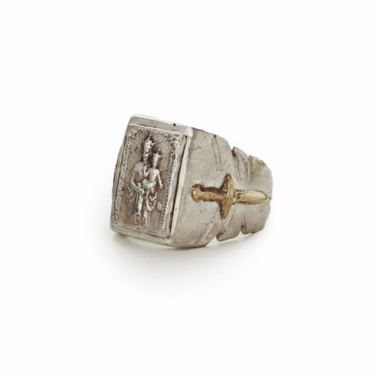 image of sterling silver souvenir biker ring with mother Mary holding baby Jesus, with brass sword and shield crest, side view