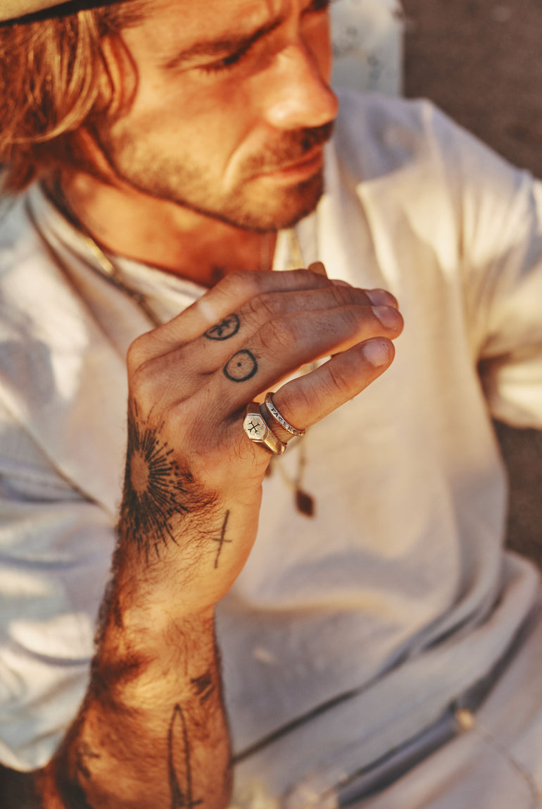 Lifestyle photo image of man, focus on hand with Sacred Love ring