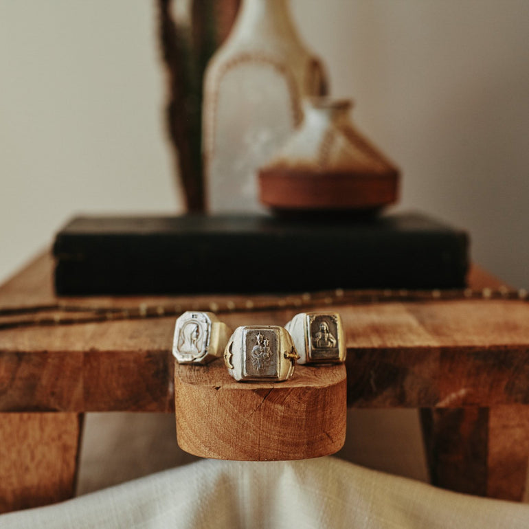 image of 3 sterling silver souvenir biker rings, with Mother Mary and Jesus, lifestyle photo