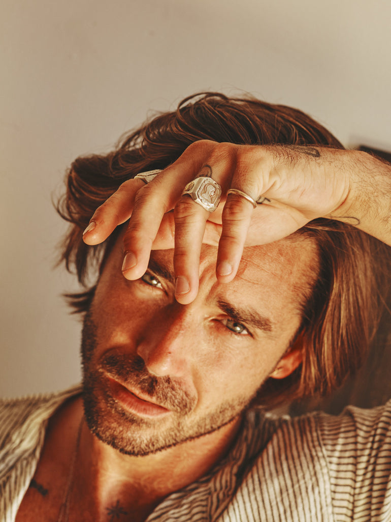 lifestyle photo image of man holding hand above face, wearing Mother Mary sterling silver ring